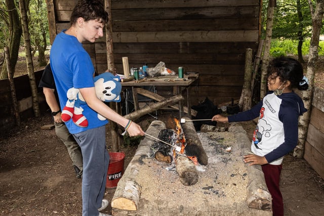 Toasting marshmallows over the campfire at Lodge Hill's family SEND event