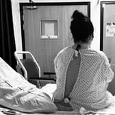Beth, the founder of Felix's Flame sat on a hospital bed. (Image: Beth Cooper)