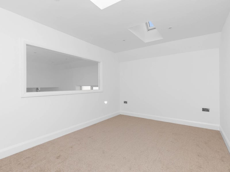 One of the bedrooms has a large picture window that overlooks the living space