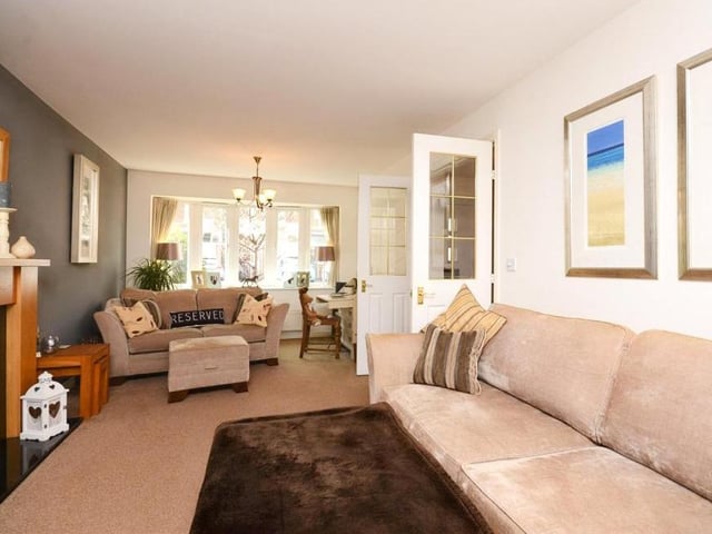 The lengthy living room is bright and spacious. A feature fireplace adds to the warmth, while the window, overlooking the front of the property, adds to the natural light.