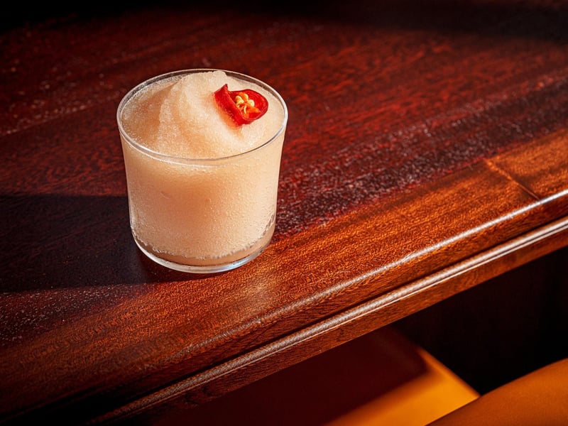 A Spicy Guava Frosé - A tumbler of rosé ice-crush with guava fruit, and candied red chilli.