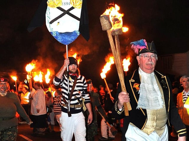 Lindfield Bonfire Night 2008. Harbour Master Will Blunden leads the Lindfield Bonfire. The Lindfield banner was shrouded with a black cloth to mark the passing of Bonfire Captain Kim Lucas