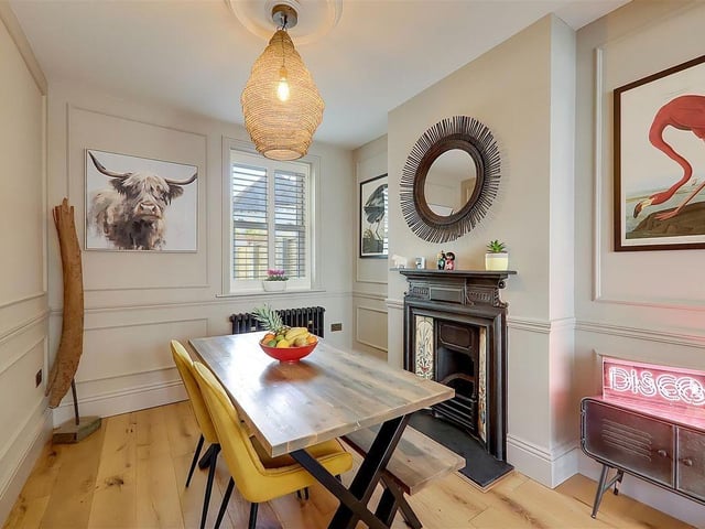 The separate dining area has an iron fireplace