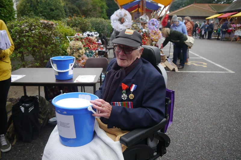 Second World War veteran Len Gibbon helping collect donations at the entrance