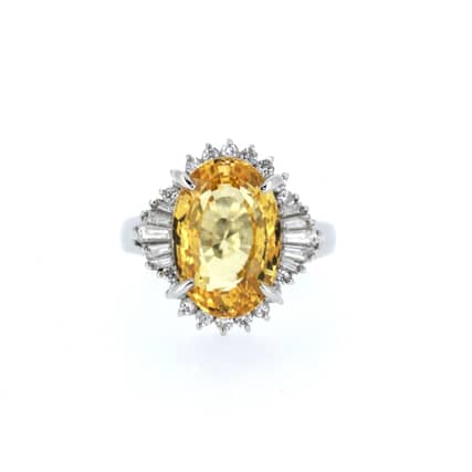 Natural orange-yellow sapphire and 1.2-carat diamond cluster ring set in 18ct white gold. Price £18,950 from S. Greenstein & Co. Ltd.