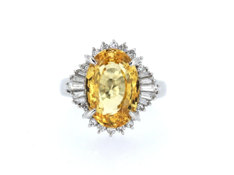 Natural orange-yellow sapphire and 1.2-carat diamond cluster ring set in 18ct white gold. Price £18,950 from S. Greenstein & Co. Ltd.