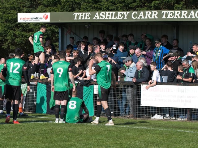 Burgess Hill Town players, fans and staff celebrate surviving in the Isthmian south east division at the end of their 0-0 draw with Beckenham