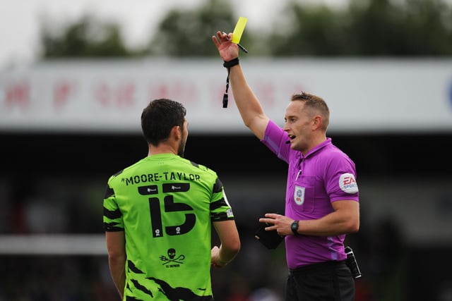 James Bell shows a yellow card to Jordan Moore-Taylor. The leaders have had 47 yellow cards and two double bookings this season.