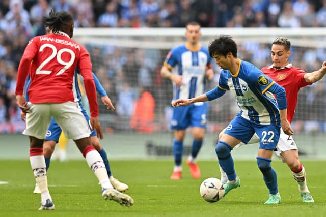 vie with Brighton's Japanese midfielder Kaoru MitomaManchester United's Brazilian midfielder Antony (R) and Manchester United's English defender Aaron Wan-Bissaka during the English FA Cup semi-final football match between Manchester United and Brighton and Hove Albion at Wembley Stadium in north west London on April 23, 2023. (Photo by Glyn KIRK / AFP) / NOT FOR MARKETING OR ADVERTISING USE / RESTRICTED TO EDITORIAL USE (Photo by GLYN KIRK/AFP via Getty Images)