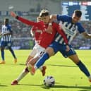 Brighton's Polish midfielder Jakub Moder (R) vies with Manchester United's Argentinian midfielder Alejandro Garnacho