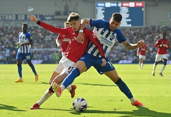 Brighton's Polish midfielder Jakub Moder (R) vies with Manchester United's Argentinian midfielder Alejandro Garnacho