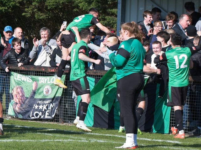 Burgess Hill Town players, fans and staff celebrate surviving in the Isthmian south east division at the end of their 0-0 draw with Beckenham