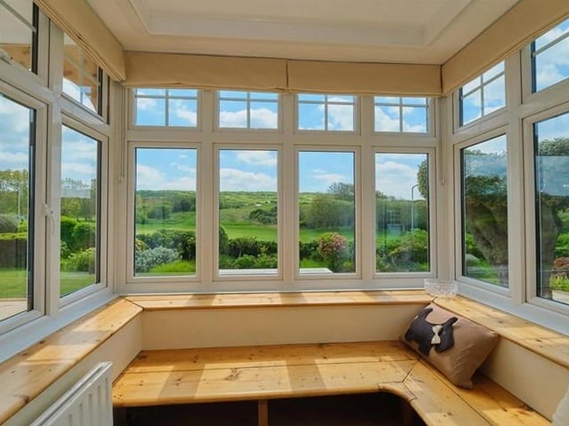 Bay windows with seating to take advantage of the infinity garden view
