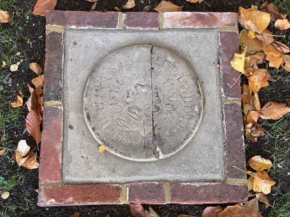 The district council have cleaned the stone, set in concrete and framed it with bricks to protect the historical artefact.