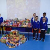 Our Lady Queen of Heaven pupils collecting goods for Harvest Festival