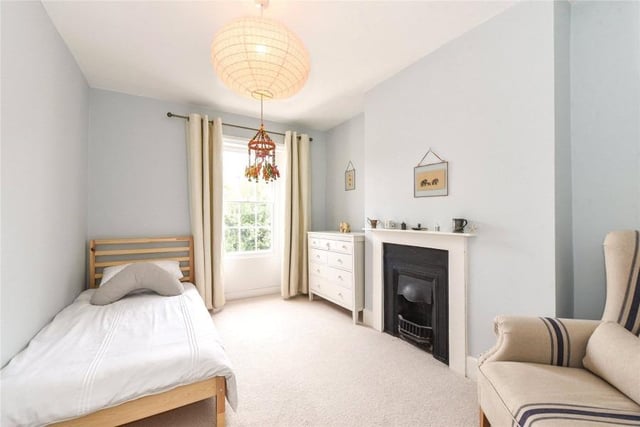 The property's bedrooms have plenty of natural light and a beautiful fireplace.