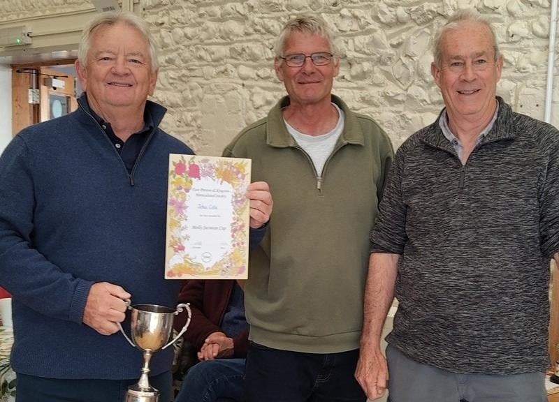 John Cole, left, receiving the Molly Secretan Cup from Chris Hill and Simon Smith
