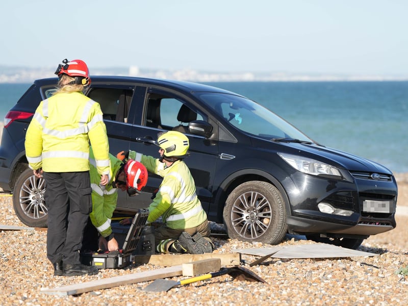 Police and the fire service helping at car on Worthing Beach on Monday evening, June