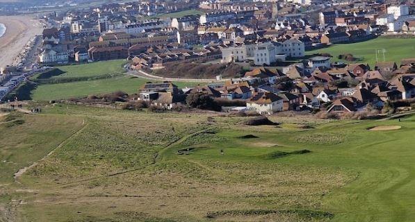A coastal town in East Sussex with affordable housing options and a range of amenities, including a high street with shops and restaurants, a leisure centre, and a train station