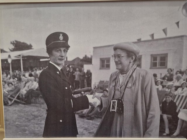 Police Woman Margaret Short being congratulated by Gladys Moss for being the first female to receive the Baton of Honour for best recruit in August 1959