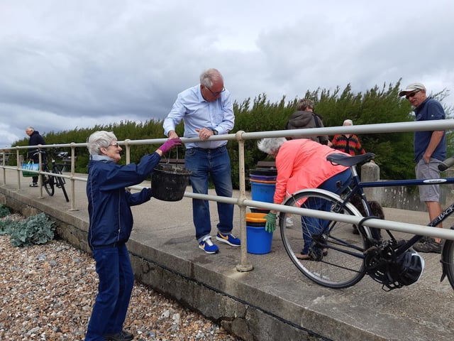 A bucket chain of volunteers from Ferring History Group and Ferring Conservation Group, including Worthing West MP Sir Peter Bottomley, form a bucket chain to bail out nine inches of water from the Ferring pillbox