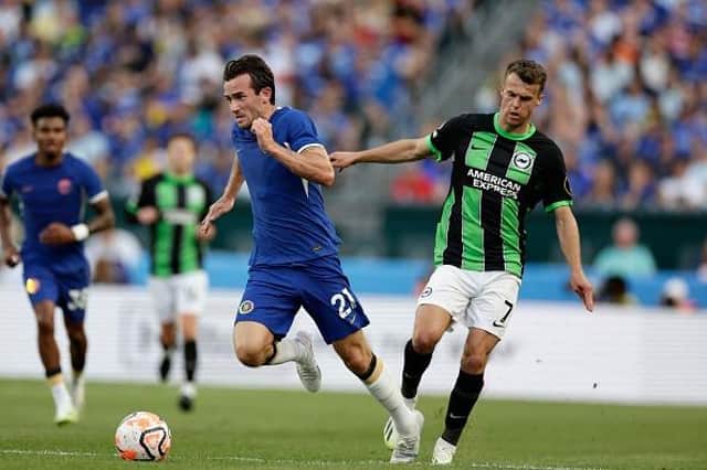 Brighton's Solly March is booked for a foul on Chelsea's Ben Chilwell
