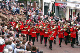 The band marches through North Street, Chichester, leading members of the 47 Regt Royal Artillery