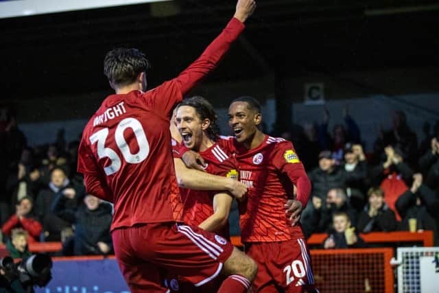 Danilo Orsi is at the centre of the celebrations after scoring Crawley Town's second goal against Swindon Town on New Year's Day. Picture: Eva Gilbert