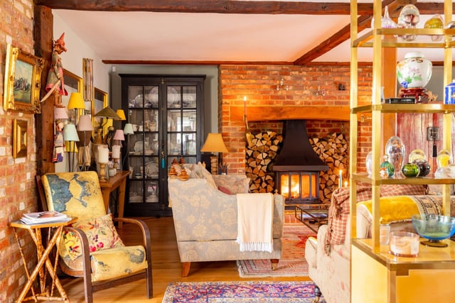 "A sumptuously sized drawing room, it lends itself to all seasons: light and airy in the summer months and cosy and embracing in the wintertime, snuggled up in front of the log-burning stove, nestled within its enormous red-brick surround. Exposed beams add character, as light flows in through several cottage style windows. Throughout the home a classic palette from Farrow & Ball and Zoffany embellishes the walls for a homely, stylish feel."