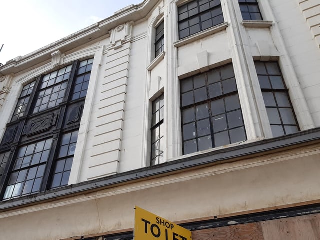 Windows above an empty shop that was once Pizza Hut but before that, housed a coffee roasting business that many will remember for its distinctive aromas