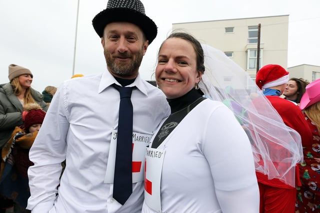 Some 385 people braved the ice cold sea water on New Year's Day 2024. Two newly weds Miranda and Marc Phillips