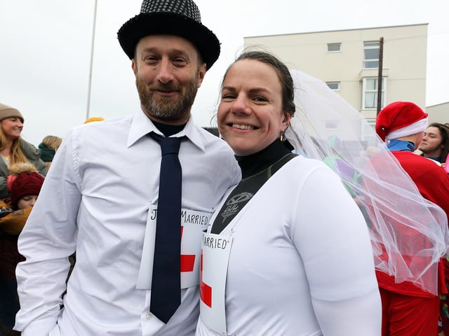 Some 385 people braved the ice cold sea water on New Year's Day 2024. Two newly weds Miranda and Marc Phillips