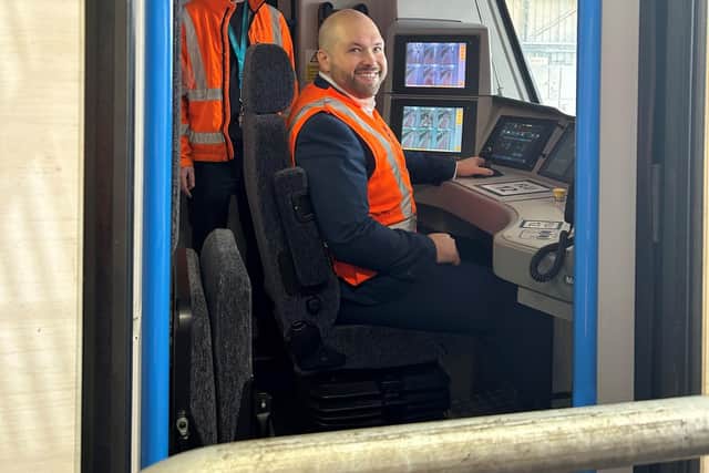 Peter Lamb MP in the driving seat of a Class 700.