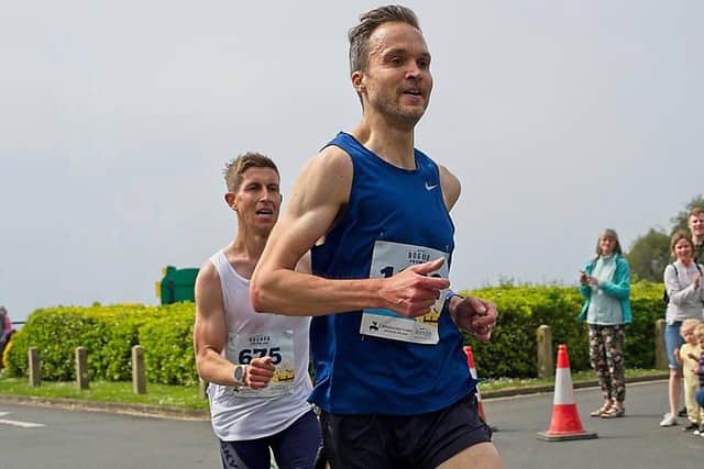 Paul Navesey (white) is about to launch his sprint finish to blast past Patrick Martin and win the Prom 10k