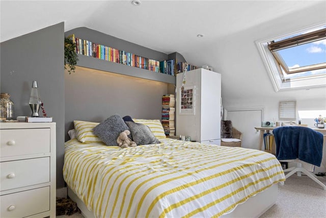 A skylight gives this bedroom a sense of scale and character.