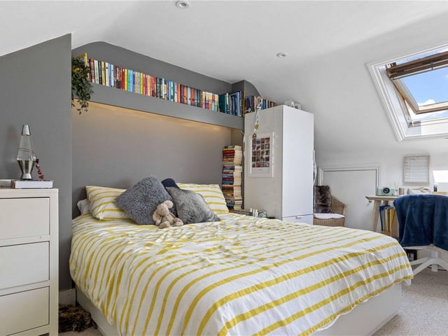 A skylight gives this bedroom a sense of scale and character.