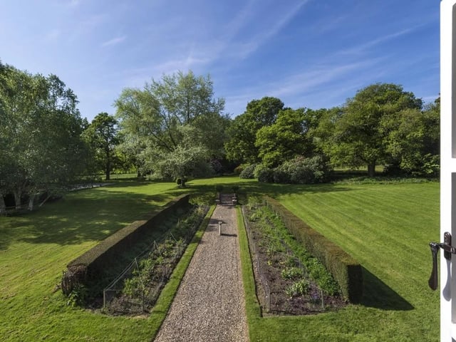 The gardens have formal lawns and paths with well stocked herbaceous borders