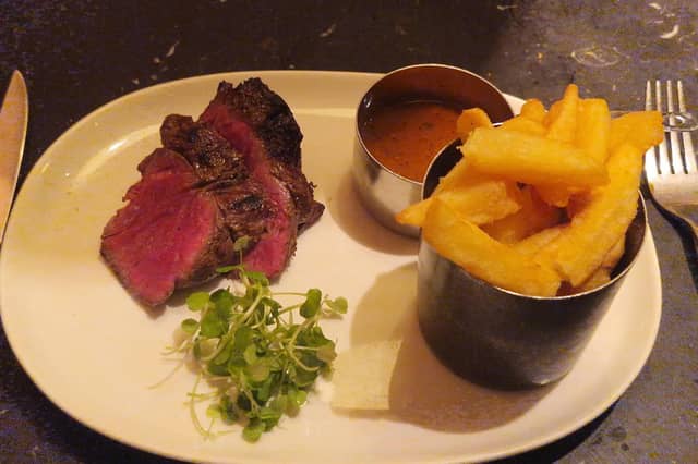 The Chateaubriand arrived in thick slices, revealing a vivid pink centre beneath a deeply browned exterior. Alongside it sat a pot piled with chunky golden chips, a separate serving of peppercorn sauce and a little greenery.