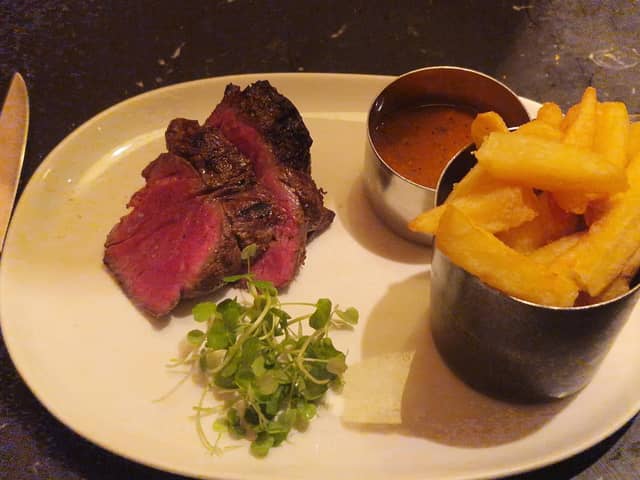 The Chateaubriand arrived in thick slices, revealing a vivid pink centre beneath a deeply browned exterior. Alongside it sat a pot piled with chunky golden chips, a separate serving of peppercorn sauce and a little greenery.