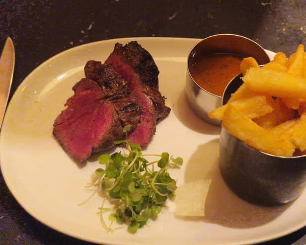 The Chateaubriand arrived in thick slices, revealing a vivid pink centre beneath a deeply browned exterior. Alongside it sat a pot piled with chunky golden chips, a separate serving of peppercorn sauce and a little greenery.