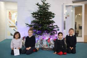 Pre-prep children at Highfield and Brookham with some of the hampers raffled for charity