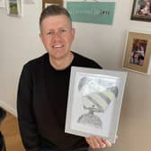 Phil Heckels, known as Hercule Van Wolfwinkle, with a pet portrait he drew to to raise money for charity