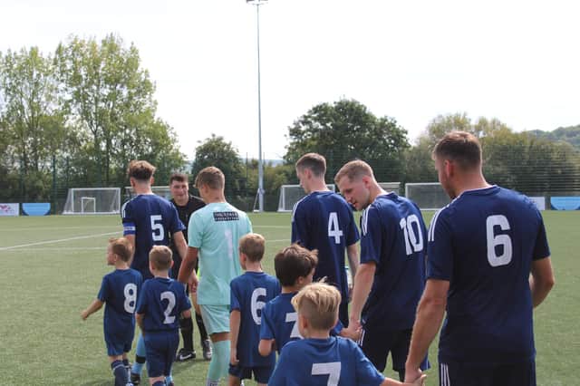 Ringmer players walk out with mascots before Saturday's match. Picture: Will Hugall