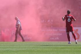 A flare on the pitch at Crawley Town before the Newport County game at the Broadfield Stadium. Picture: Natalie Mayhew/Butterflyfootie