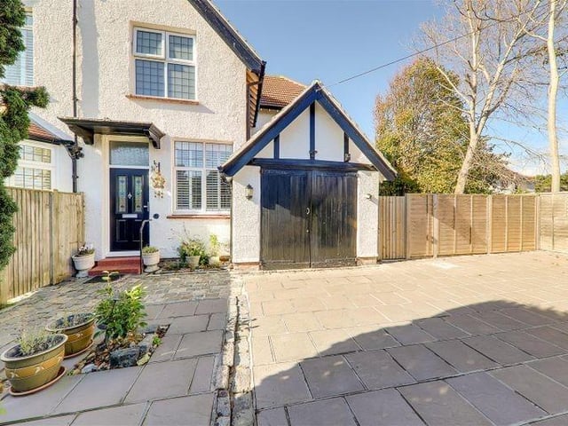The private drive has parking for three or four vehicles and it leads to a larger-than-average internal garage