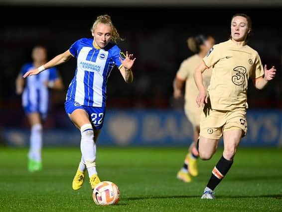 Katie Robinson of Brighton & Hove Albion runs with the ball from Niamh Charles of Chelsea during the FA Women's Super League match