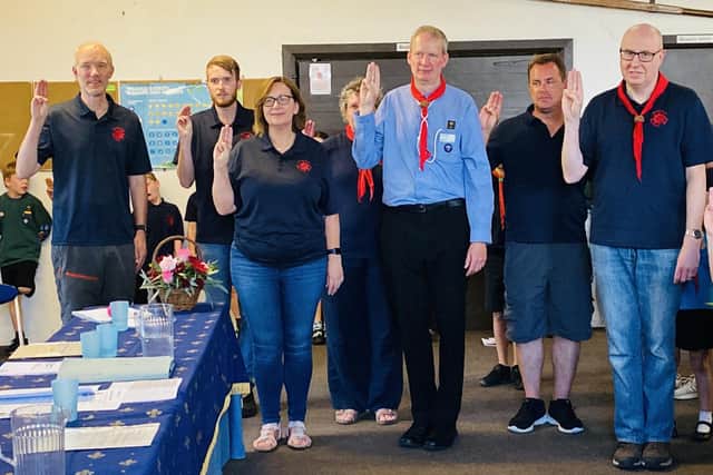 District commissioner Al Chartres leads the 8th Worthing Sea Scouts leaders in renewing their Promise after receiving Wood Badges and long-service awards