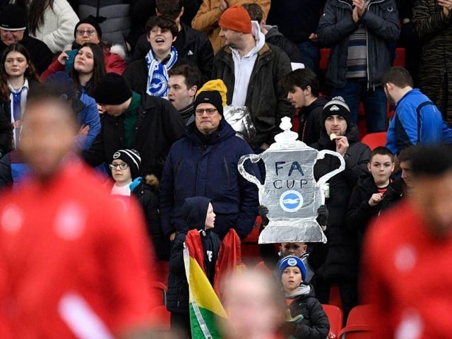 A young Brighton fan holds up a tin-foil FA Cup in the crowd as the teams walk out ahead of kick-off in the English FA Cup fifth round football match between Stoke City and Brighton and Hove Albion at the bet365 Stadium, in Stoke on Trent, central England, on February 28, 2023. (Photo by OLI SCARFF/AFP via Getty Images)
