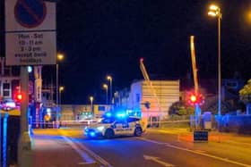 Police guarding the stuck level crossing gates in South Farm Road, Worthing
