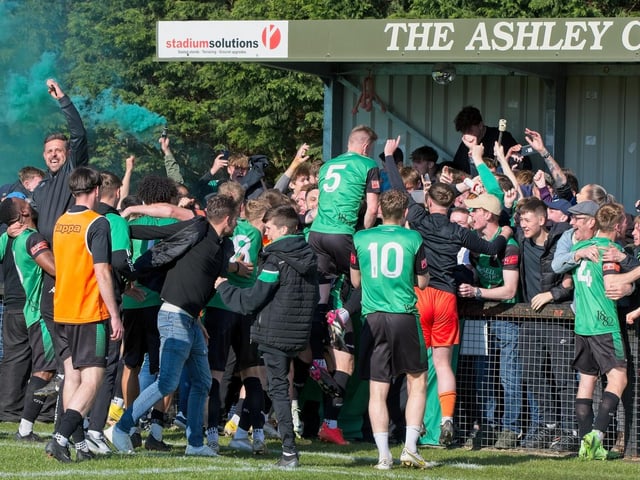 Burgess Hill Town players, fans and staff celebrate surviving in the Isthmian south east division at the end of their 0-0 draw with Beckenham
